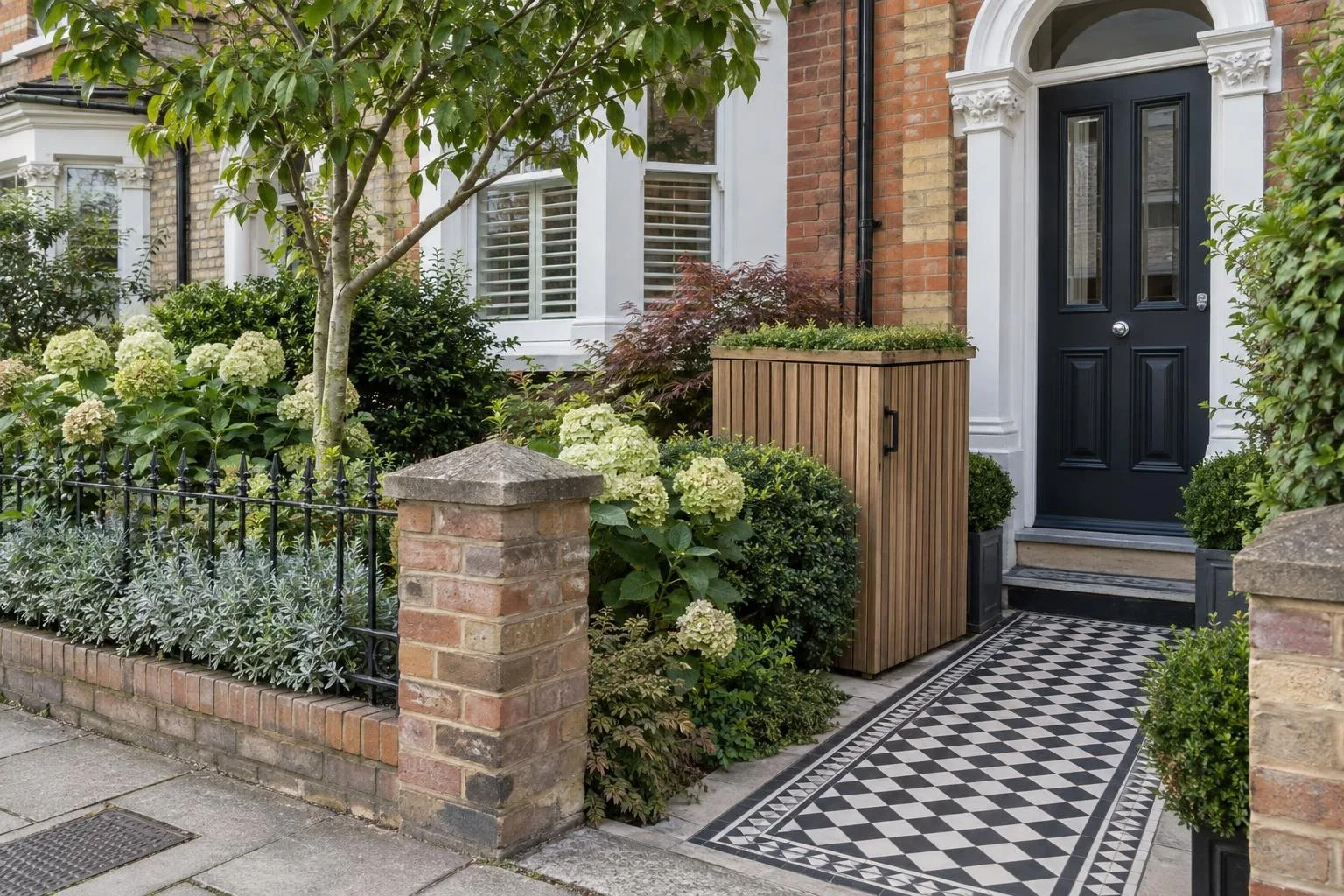 Composite slatted two-bin wheelie bin store on a level paved pad beside a driveway Composite slatted two-bin wheelie bin store on a level paved pad beside a driveway