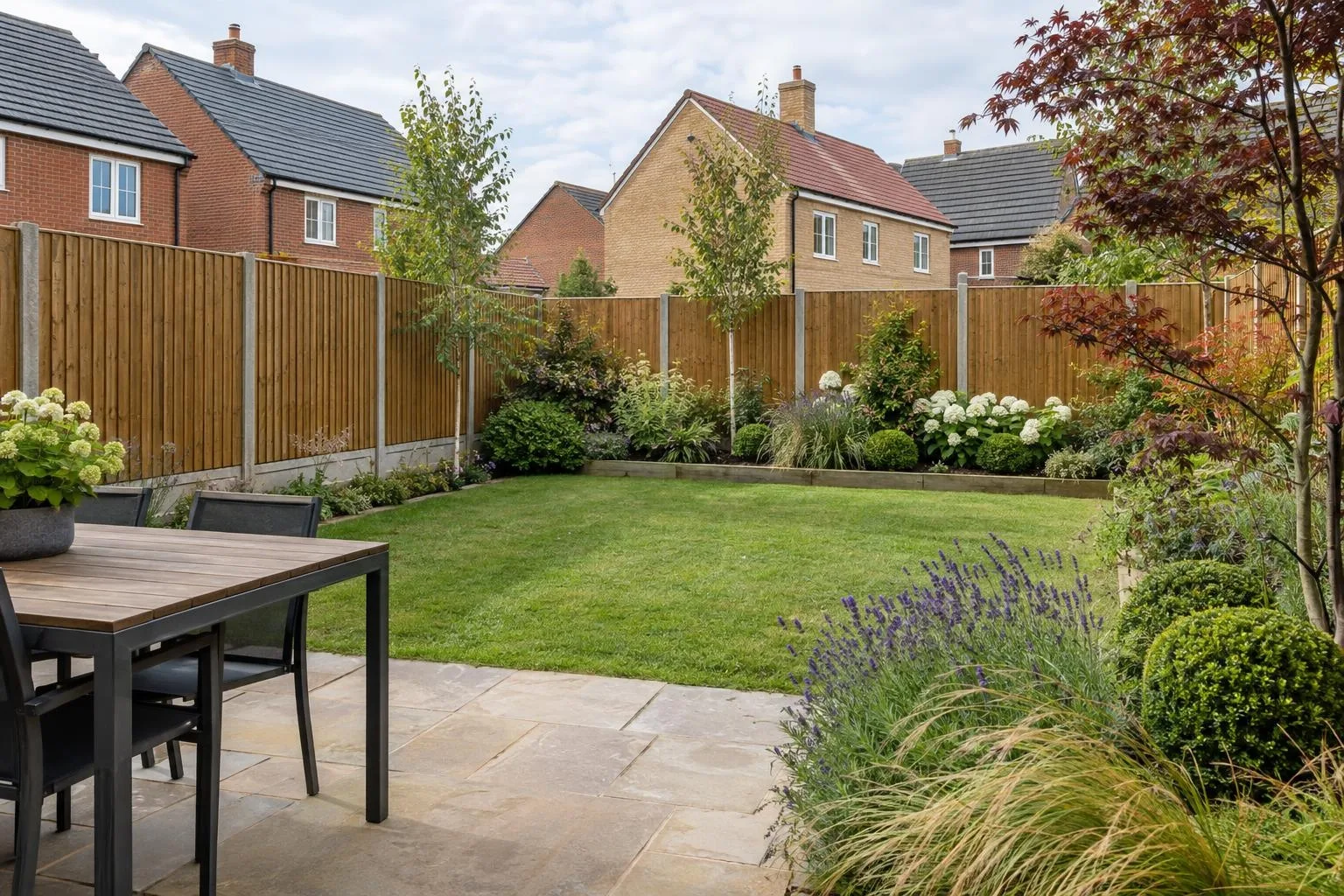 New closeboard fence on concrete posts with gravel boards around a new-build garden, brick houses beyond New closeboard fence on concrete posts with gravel boards around a new-build garden, brick houses beyond